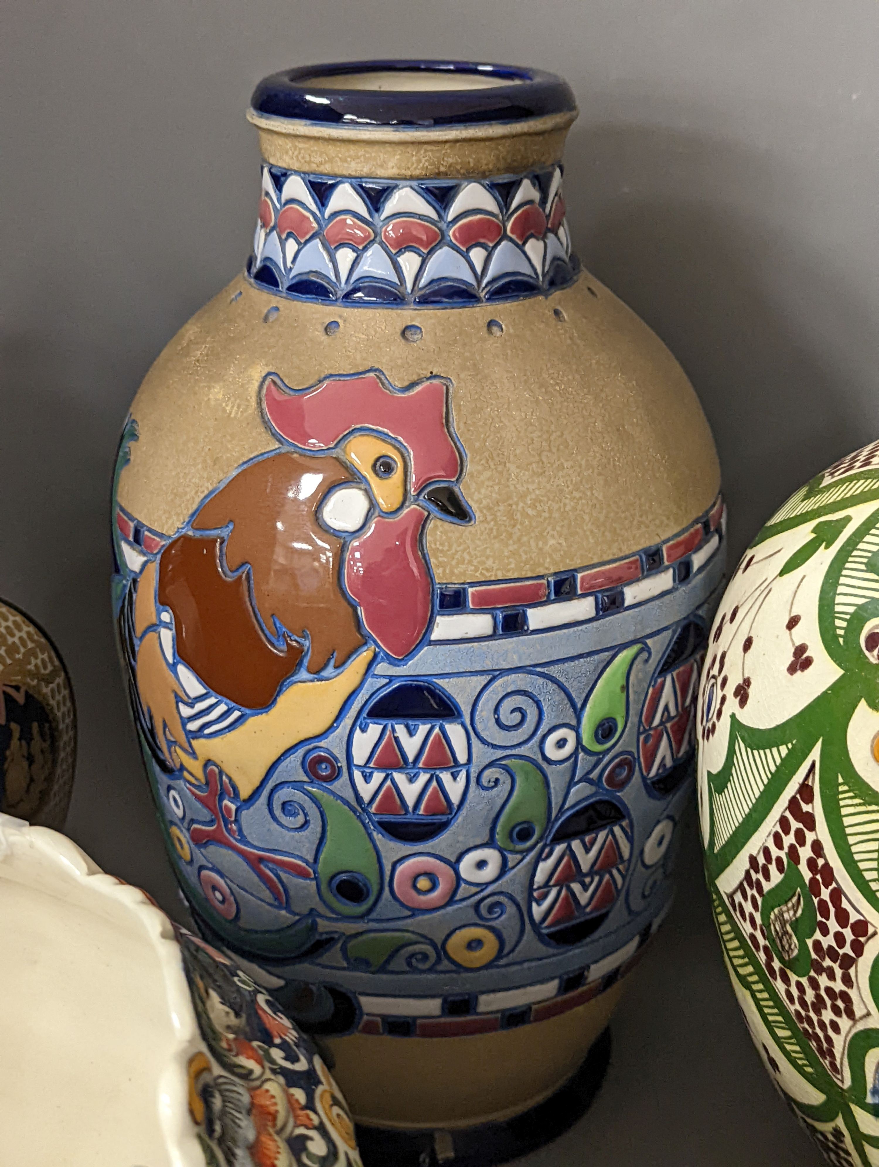 A Mont Saint Michael jardiniere, a lidded jar, two vases and an Amphora chicken decorated vase, Amphora vase 36 cms high.